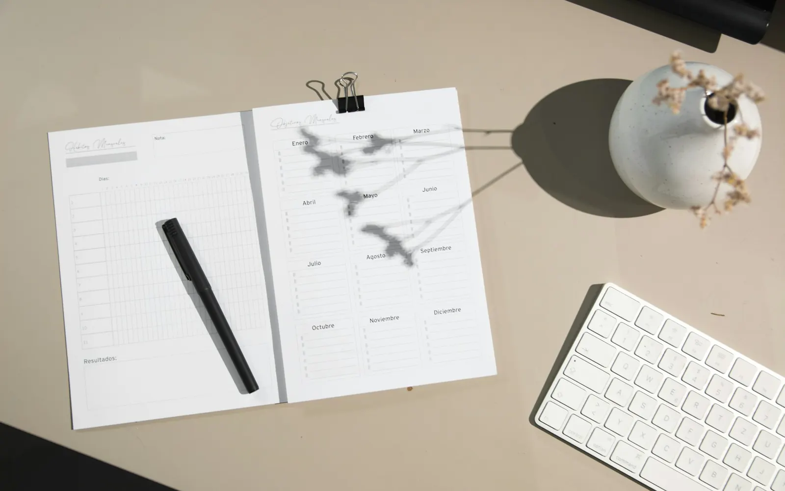 Illustrative photo: a bound printed report with notes, a pen and a keyboard. Not a sample of the Customer Case Study deliverable.