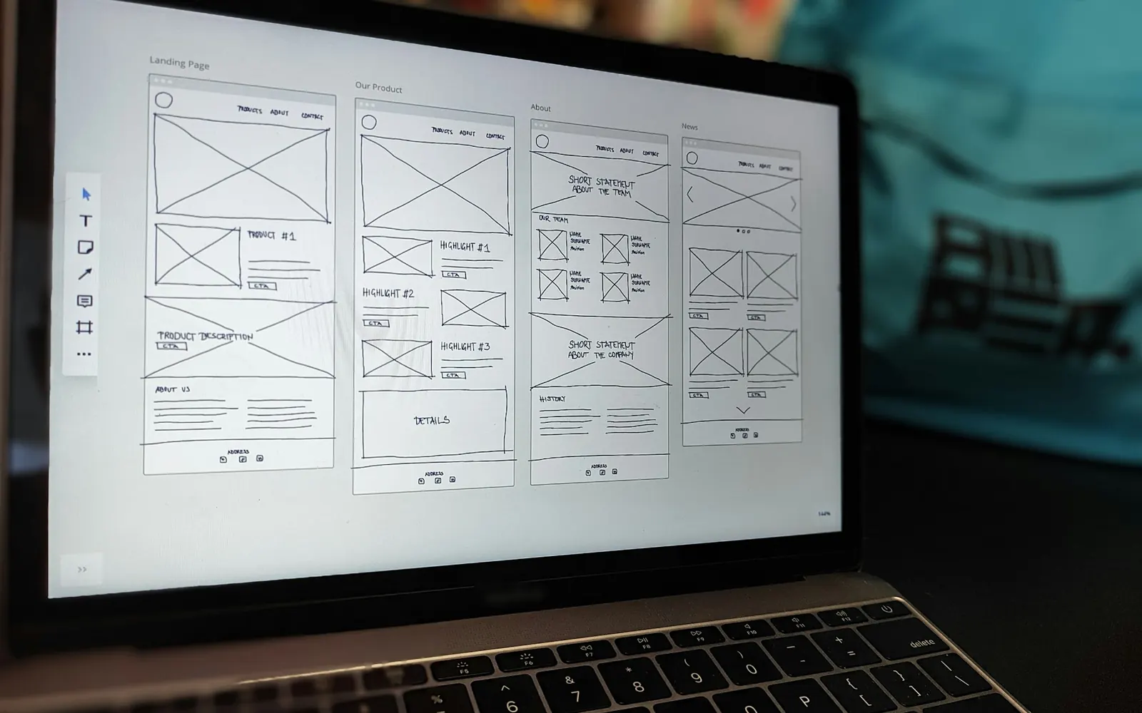 Illustrative photo: a laptop showing landing-page wireframes. Not a sample of the Landing Page Build deliverable.